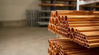 Copper pipes stacked in warehouse for plumbing construction industrial supply manufacturing building materials metal tubing installation repair work.