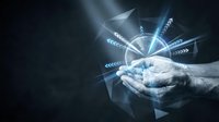 Male hand holding glowing digital compass with directional arrows and light rays on dark background, representing navigation, guidance, technology solutions, and business direction.