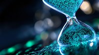 Digital hourglass with glowing turquoise particles flowing through glass on dark background with bokeh lights, representing time management and technology concept.