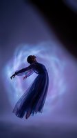 Ethereal woman in flowing blue dress dancing gracefully against mystical purple light background with dramatic shadows and spiritual atmosphere.
