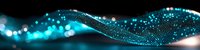 Glowing blue particle wave with bokeh light effects on black background creates dynamic flowing motion and energy visualization for technology designs.