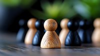 Wooden chess pawn in focus against blurred black pieces, symbolizing leadership, strategy and standing out from crowd on textured chess board surface.