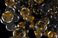 Golden amber glass spheres floating in dark space with reflective surfaces and transparent textures for luxury design projects.