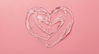 Clear glossy lip gloss heart shape on pink background for beauty cosmetics skincare Valentine romance love makeup products advertising design.