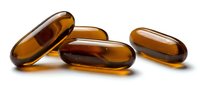 Amber colored gel capsules scattered on white background for pharmaceutical and supplement industry marketing materials.