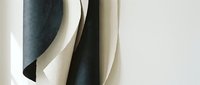 Abstract curved paper forms creating flowing sculptural composition with soft shadows on neutral background for modern interior design and artistic projects.