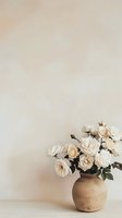 Elegant white roses in rustic clay vase against neutral beige wall background, minimalist floral composition with soft natural lighting and copy space.
