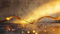 Golden silk ribbon flowing in magical light beam with glowing particles and bokeh effect on reflective surface, creating luxurious atmosphere.