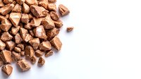 Copper metal nuggets or fragments scattered on white background, raw material for industrial manufacturing or jewelry making.