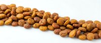 Mixed nuts and legumes scattered on white background isolated for healthy snacking and cooking ingredients in food photography.