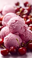 Creamy cherry ice cream scoops surrounded by fresh red cherries on dark surface, showcasing summer dessert with natural fruit flavor.