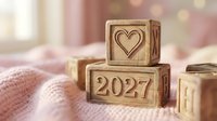 Wooden blocks stacked with heart symbol and 2027 date on soft pink knitted fabric, symbolizing love, new year planning, and future goals for romantic occasions.