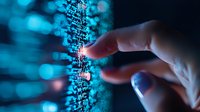 Finger touching digital data stream with glowing blue bokeh effect, representing cybersecurity, big data analytics and digital transformation in modern technology.