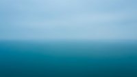 Abstract blue gradient background with soft color transition from light sky blue to deep teal, creating calm atmospheric mood for modern design projects.