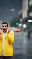Man in yellow raincoat expressing surprise during heavy rainfall on urban street with blurred city lights and traffic signals in background. Suitable for weather, emotions, and lifestyle content.