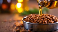 Honey drizzling over fresh roasted coffee beans in metal container, warm bokeh lights background creates cozy atmosphere, macro food photography with selective focus.
