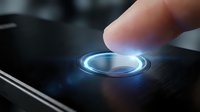 Human finger touching glowing blue circular button on dark digital interface with futuristic holographic light effects for technology and user interaction concepts.