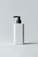 White cosmetic pump bottle with black dispenser on light gray background, minimalist product photography for beauty and skincare packaging mockup.