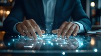 African American businessman hands typing on futuristic transparent keyboard with glowing blue light effects and digital network connections in dark office.