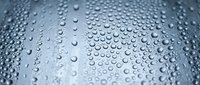 Water droplets on smooth metallic surface creating abstract pattern with reflective blue-gray tones and natural condensation texture for modern design projects.
