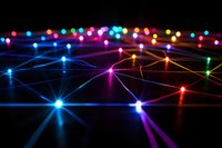Colorful glowing network of interconnected light points and beams against dark background creating futuristic technology visualization pattern.