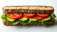 Fresh vegetarian sandwich with sliced tomatoes, avocado and lettuce on whole grain bread against white background, appetizing healthy lunch option.