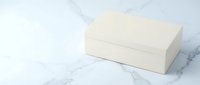 Elegant cream white rectangular box on marble surface, minimalist product packaging mockup for branding and luxury design projects.