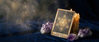 Mystical tarot card reading setup with amethyst crystals and burning candle creating magical atmosphere for spiritual guidance and divination practices.