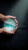 Male hands holding glowing brain hologram against dark background. Represents artificial intelligence, innovation, technology, and digital transformation concepts for business and science applications.