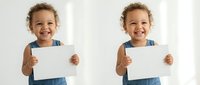 Happy mixed-race toddler girl in denim overalls holding blank white paper card with big smile, perfect for advertising and promotional materials.