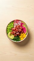 Fresh poke bowl with tuna, avocado, edamame and colorful vegetables served in wooden bowl on light wood background for healthy dining concepts.
