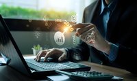 Professional businessman using laptop with digital marketing icons and analytics data overlay for business growth and technology solutions.