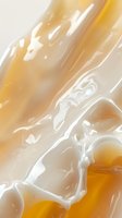 Swirling cream and honey abstract background with smooth flowing liquid texture in warm golden and white tones, creating organic marble-like patterns.