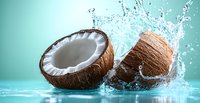Fresh coconut halves with splashing water and droplets on turquoise background, dynamic food photography composition for healthy lifestyle and refreshment concepts.