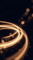 Golden light trails swirl through dark space with glowing particles and bokeh effects creating dynamic motion for luxury design backgrounds.