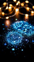 Blue glitter sparkles with warm bokeh lights creating magical atmosphere for holiday celebrations and festive decorations on dark background.
