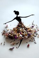 Graceful ballerina silhouette wearing dress made of delicate dried flower petals and leaves in purple and white tones against light background, artistic composition.