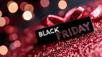 Black Friday sale text on dark background with red glitter and bokeh lights creating festive shopping atmosphere for seasonal promotions.