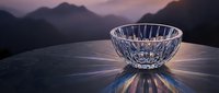 Crystal glass bowl with light reflections on marble surface, misty mountain sunset backdrop, luxury home decor and elegant lifestyle concept.