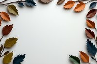 Colorful autumn leaves frame creating natural border on white background. Seasonal fall foliage arrangement with copy space for text or design elements.