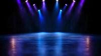 Stage illuminated by dramatic blue and purple spotlights creating mystical atmosphere with reflective floor surface, ready for performance or product presentation.