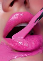 Sensual close-up of glossy pink lips with dripping liquid makeup, showcasing vibrant cosmetic artistry and beauty trends for makeup and fashion advertising.