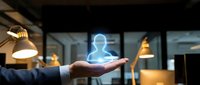 Businessman hand holding glowing holographic human figure in modern office environment with warm lighting, representing digital innovation, artificial intelligence, and future technology solutions.