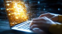 Hands typing on laptop keyboard with glowing digital data streams and golden light effects emerging from screen, representing cybersecurity and programming concepts.