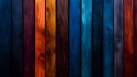 Vibrant multicolored wooden planks background with rich blue, orange, and burgundy tones creating dramatic vertical stripes pattern. Natural wood grain texture adds depth.
