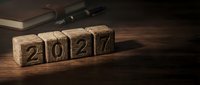 Wooden blocks displaying 2027 numbers arranged on rustic table surface for New Year planning and goal setting concepts.