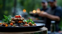 Grilled meat patty with roasted vegetables and cherry tomatoes on dark plate. Restaurant quality dish with herbs garnish for culinary and food service concepts.