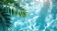 Tropical palm leaves over rippling swimming pool water with sunlight reflections creating abstract aqua patterns. Perfect for summer resort promotions.