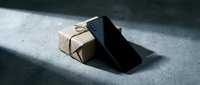 Kraft paper box with black shadow on concrete surface, suitable for product packaging and delivery concepts.