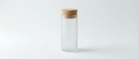 Empty glass bottle with cork stopper on white background, minimalist laboratory vial for cosmetics, medicine or essential oils storage and packaging.